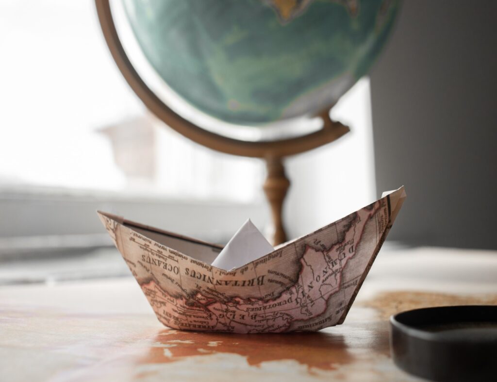 A globe with a paper boat